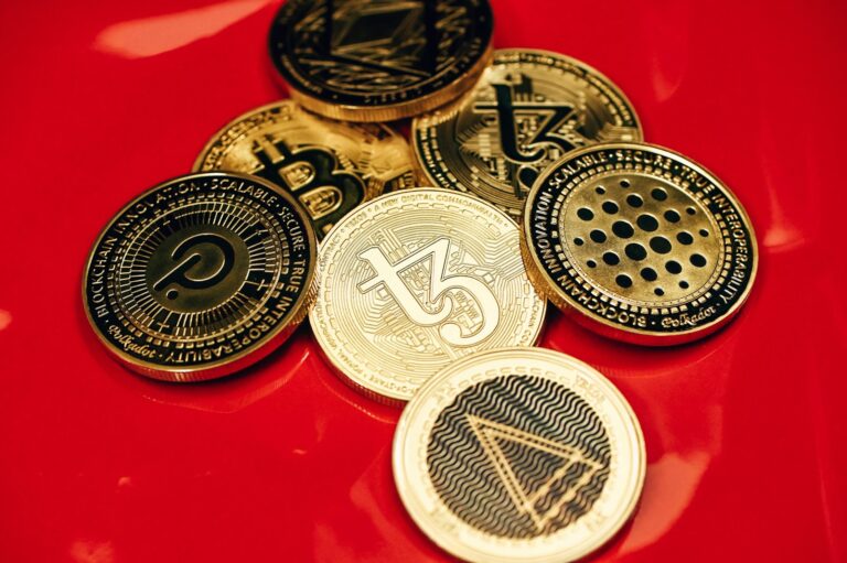 a pile of coins sitting on top of a red table