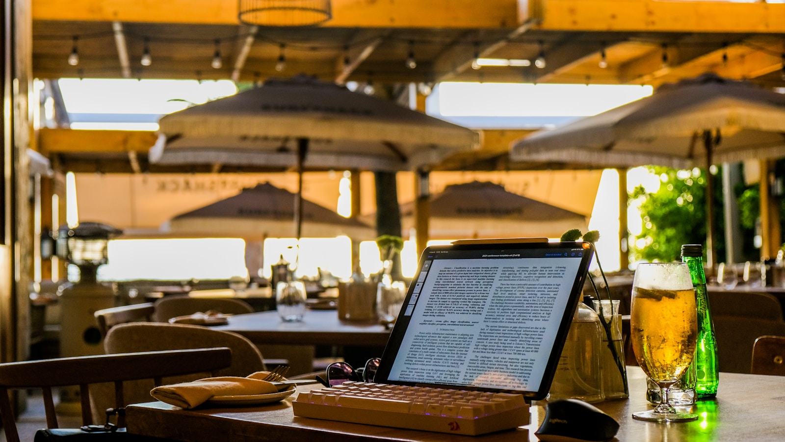 a laptop computer sitting on top of a wooden table