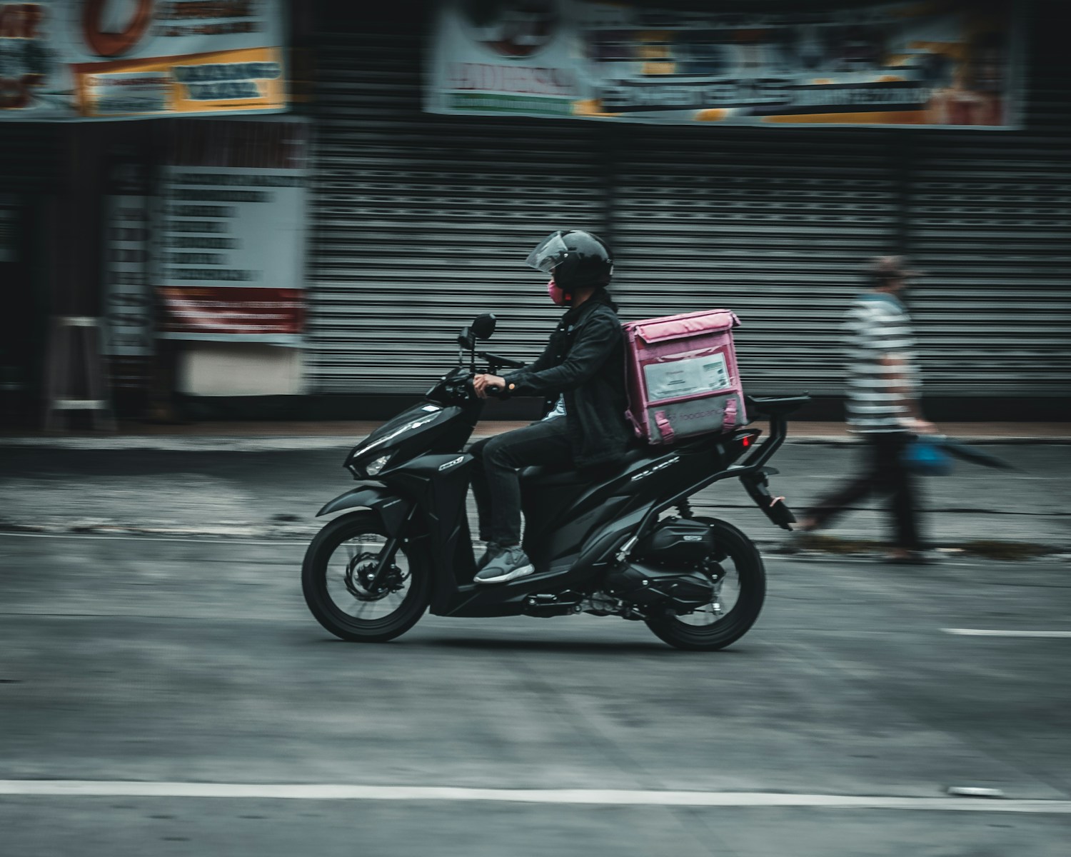 a man riding a motorcycle down a street