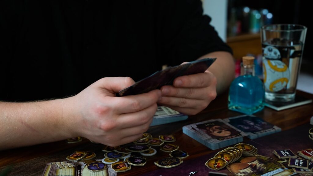 a person sitting at a table with a cell phone