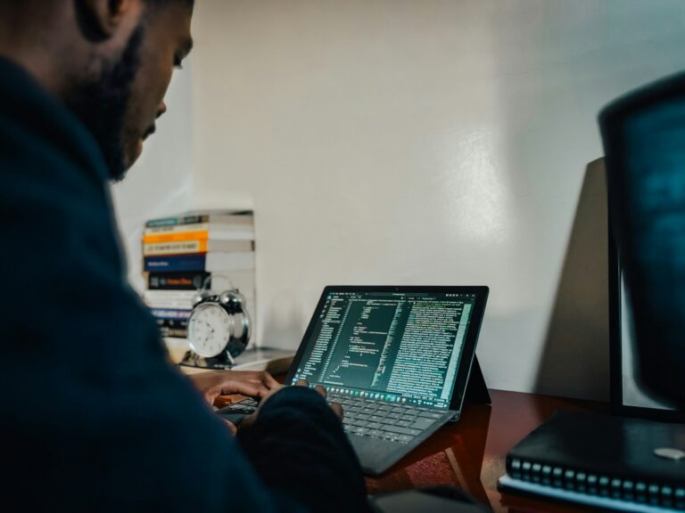 A man sitting in front of a laptop computer