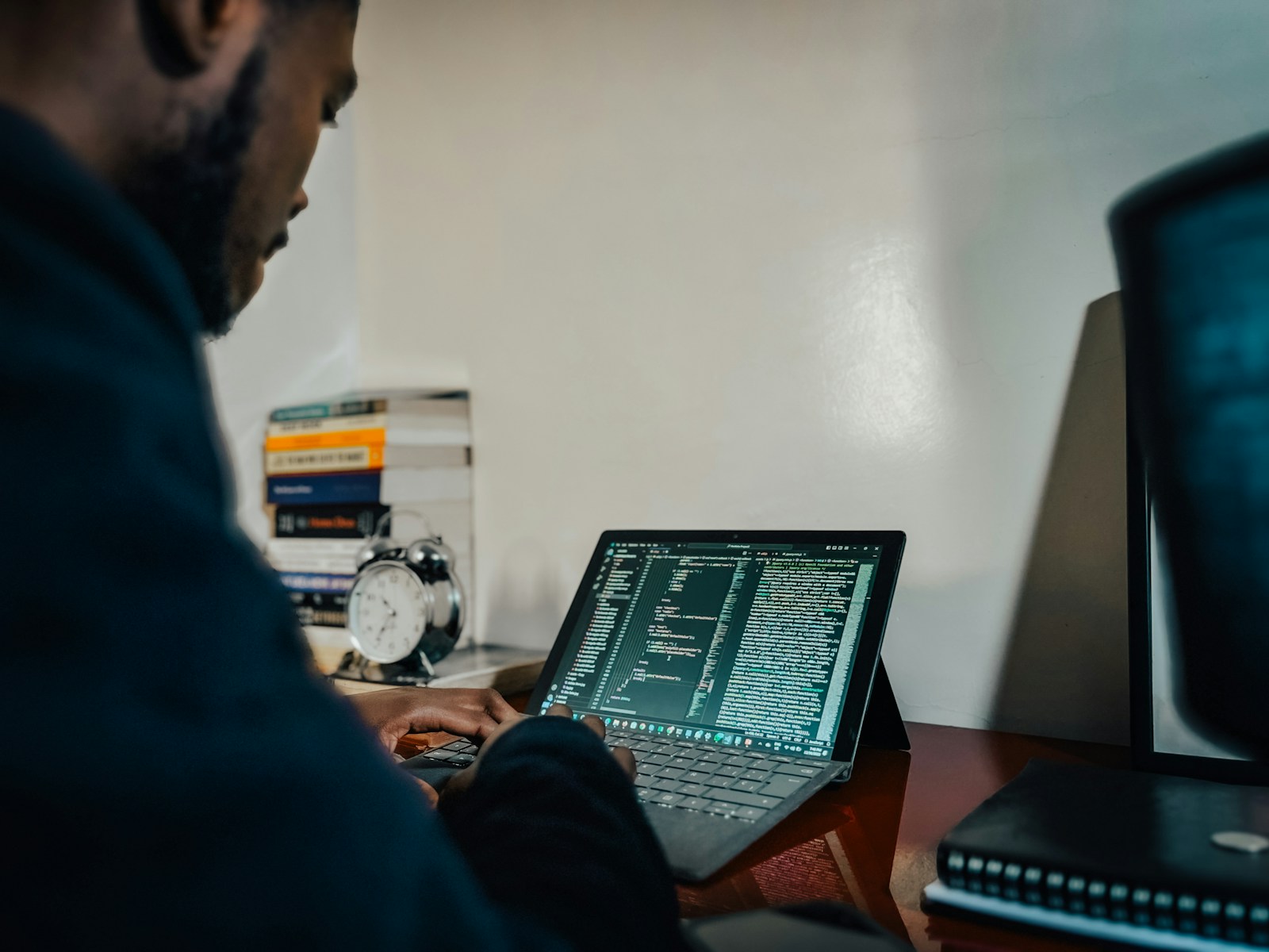 A man sitting in front of a laptop computer