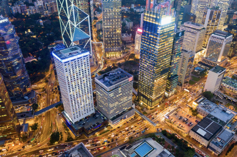 Aerial night view of Hong Kong skyline showing startup support, tax perks & global reach with company formation service.