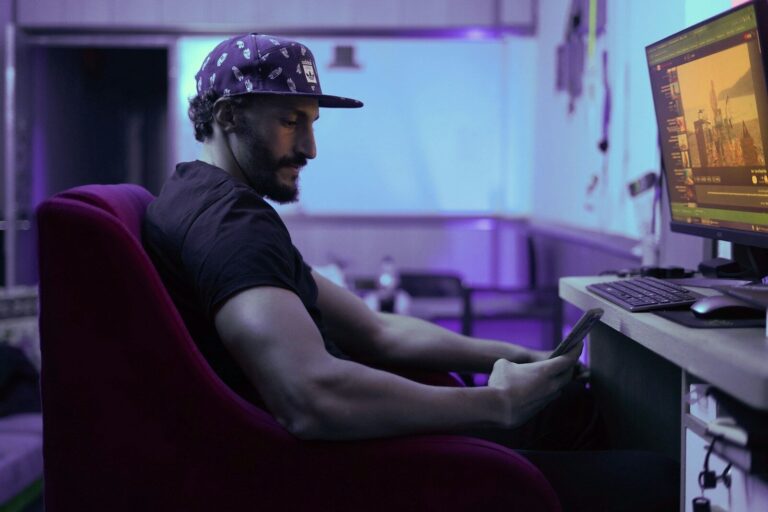 a man sitting in a chair in front of a computer