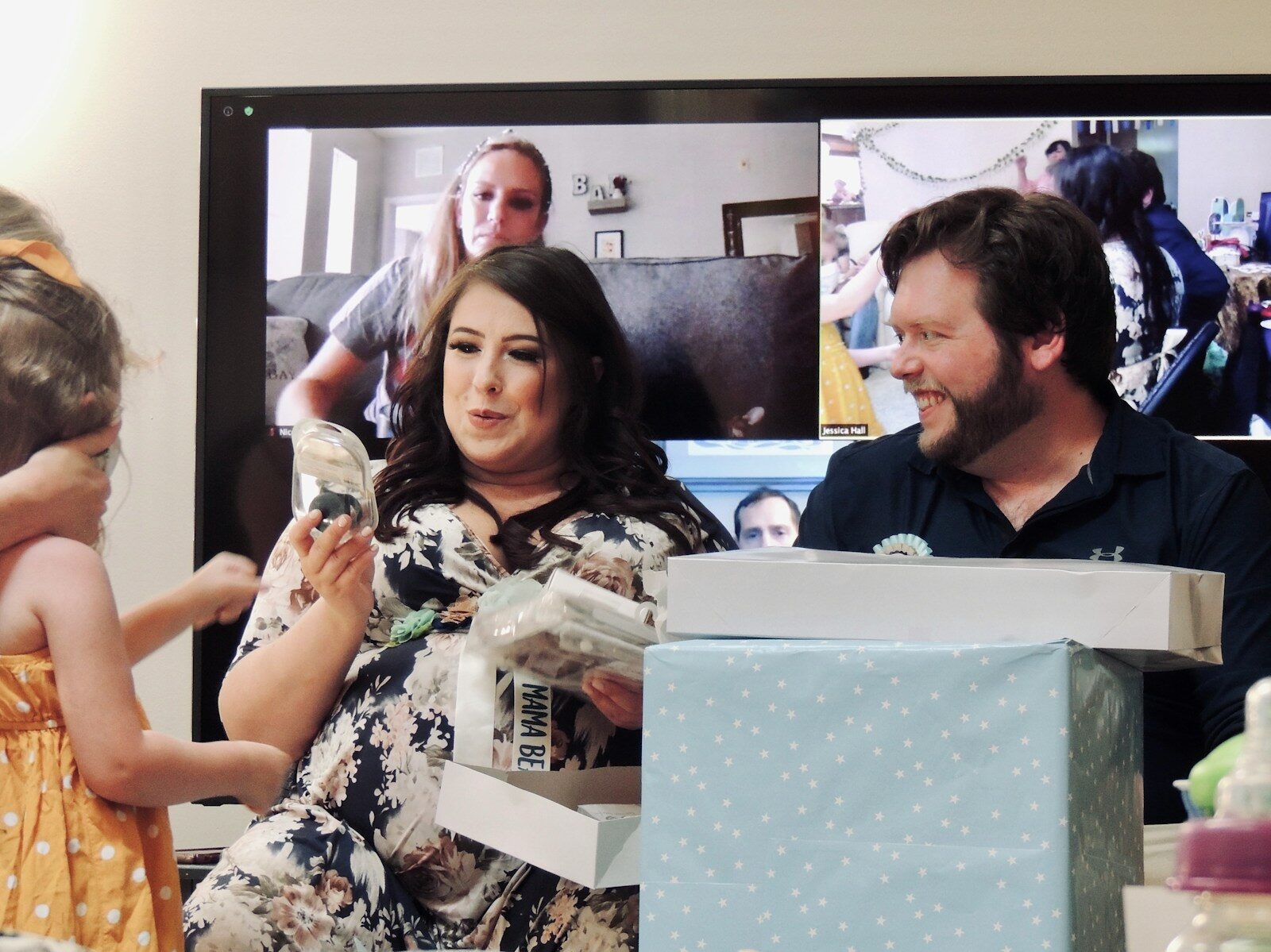 woman in white and black floral shirt holding white box